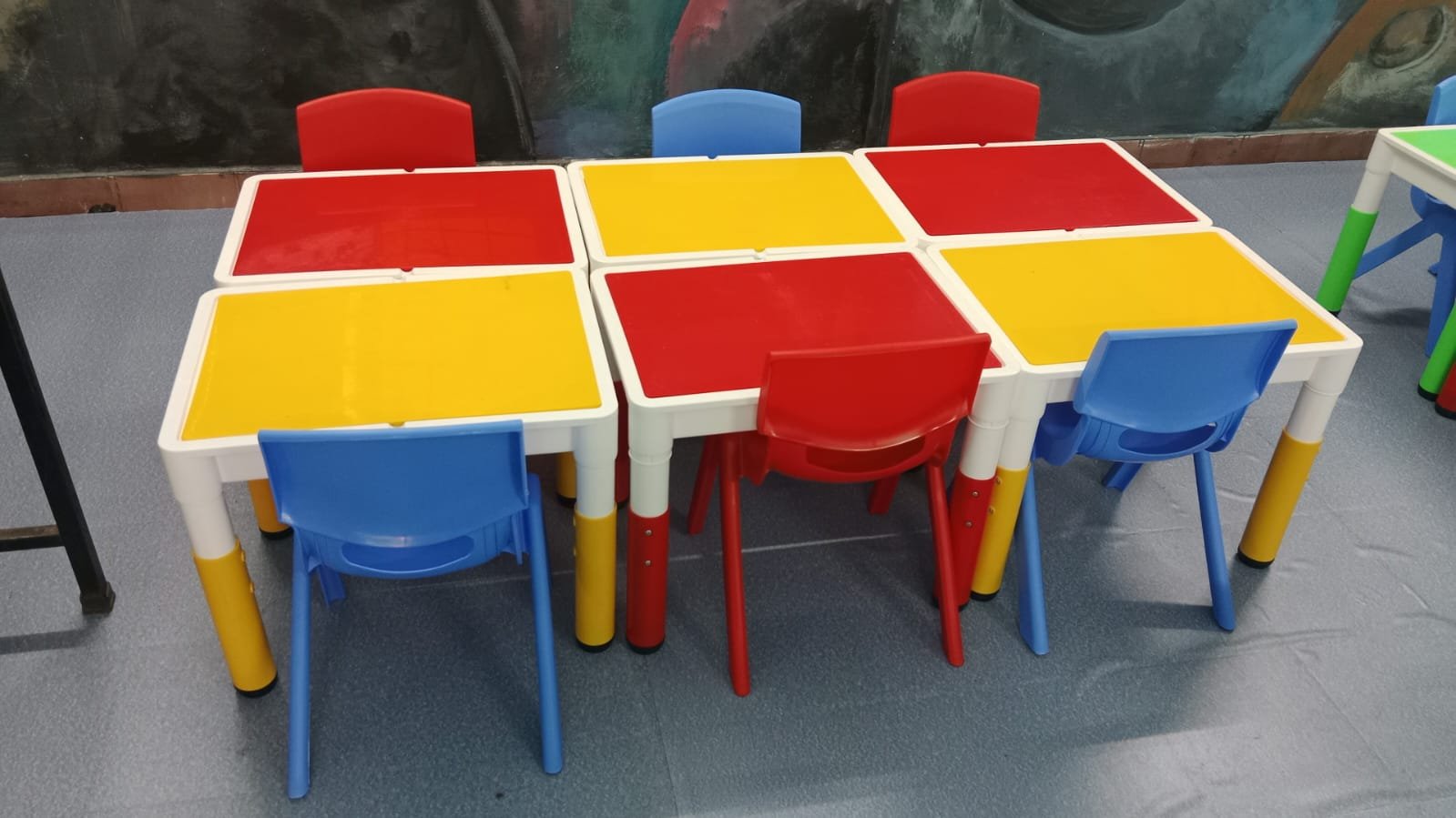 Colourful preschool tables and chairs photographed in a classroom